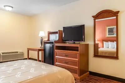 a hotel room with a bed and a flat screen tv at Quality Inn Gallipolis in Gallipolis