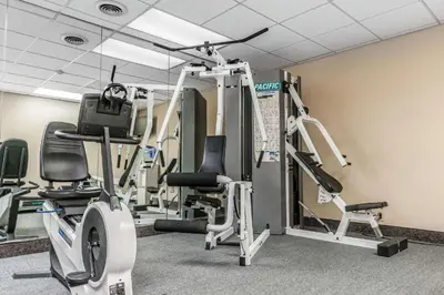 a gym with several tread machines in a room at Quality Inn Gallipolis in Gallipolis