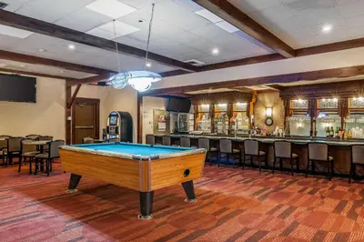a pool table in a room with a bar at Quality Inn Gallipolis in Gallipolis