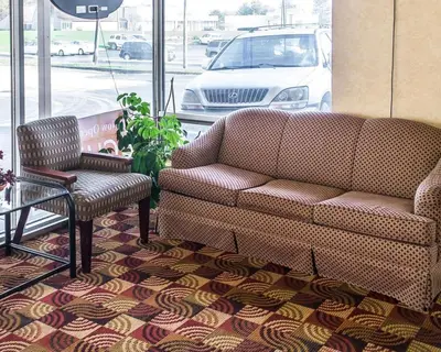 a living room with a couch and a chair at Economy Inn & Suites in Warren