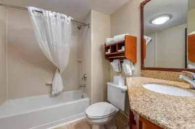 a bathroom with a toilet and a sink and a tub at Comfort Inn Oxford - University Area in Oxford