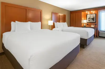 a hotel room with two beds and a desk at Comfort Inn Oxford - University Area in Oxford