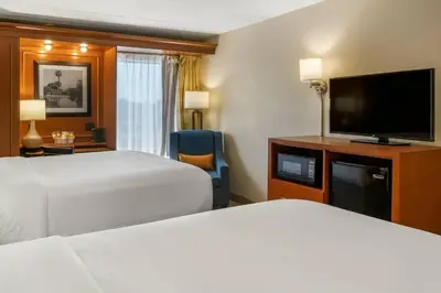 a hotel room with two beds and a flat screen tv at Comfort Inn Oxford - University Area in Oxford