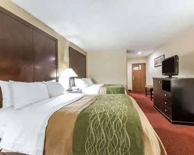 a hotel room with two beds and a flat screen tv at Quality Inn & Suites Portsmouth in Rosemount