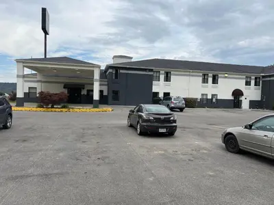 two cars parked in a parking lot in front of a building at Quality Inn & Suites Portsmouth in Rosemount