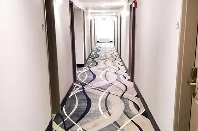 a corridor with a long hallway with a long aisle at Quality Inn & Suites Cincinnati Sharonville in Sharonville