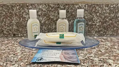two bottles of detergent and a sandwich on a table at Quality Inn & Suites Cincinnati Sharonville in Sharonville