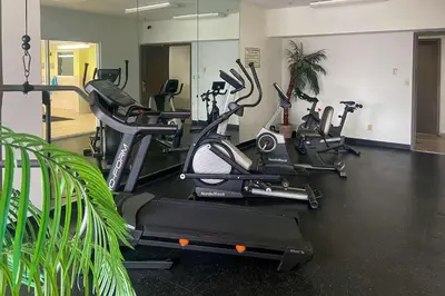 a gym with several treadmills and exercise bikes at Quality Inn & Suites Cincinnati Sharonville in Sharonville