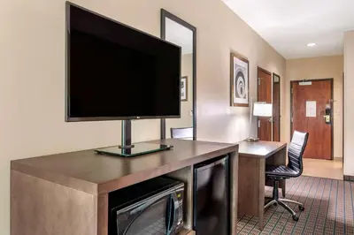 a hotel room with a flat screen tv on a desk at Comfort Inn & Suites Cincinnati Uptown Clifton in Cincinnati