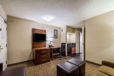 a hotel room with a desk and a computer at Comfort Inn & Suites Dayton North in Dayton
