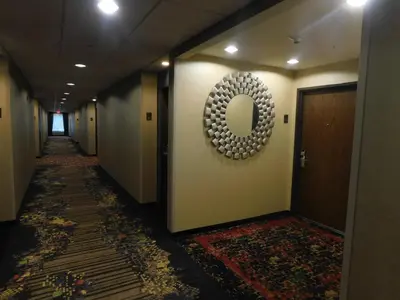a hallway with a mirror on the wall and a corridorngthngthngthngthngth at Comfort Inn St Clairsville in Saint Clairsville