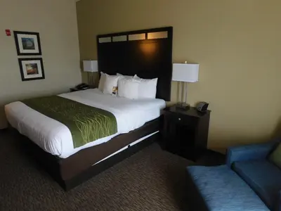 a hotel room with a large bed and a couch at Comfort Inn St Clairsville in Saint Clairsville