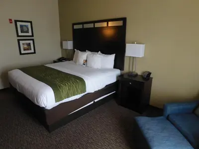 a hotel room with a large bed and a couch at Comfort Inn St Clairsville in Saint Clairsville