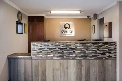 a lobby with a counter with a loyalty sign on it at Quality Inn Hall of Fame in Canton