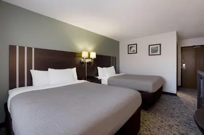 two beds in a hotel room with two at Quality Inn Hall of Fame in Canton