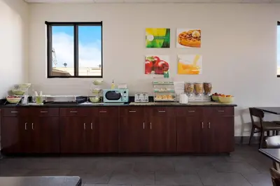 a kitchen with wooden cabinets and a window at Quality Inn Hall of Fame in Canton