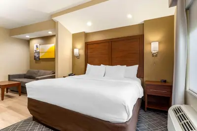 a large white bed in a hotel room at Comfort Suites Monaca in Monaca
