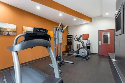 a gym with two treadmills and two exercise bikes at Comfort Suites Monaca in Monaca