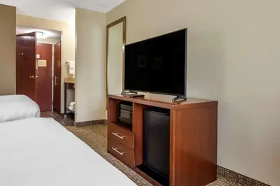 a hotel room with a flat screen tv on a dresser at Comfort Inn Meadowlands in Washington