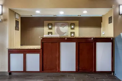 a hotel lobby with a reception desk with a mirror at Comfort Inn Meadowlands in Washington