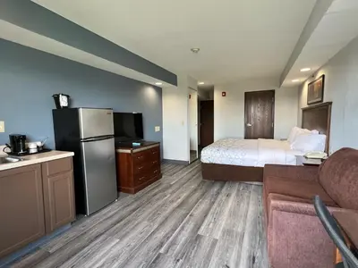 a hotel room with a bed and a refrigerator at HomeTowne Studios & Suites by Red Roof Washington in Washington