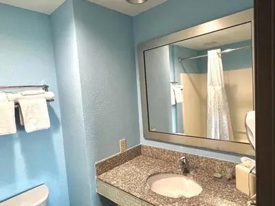 a bathroom with a sink and a mirror at HomeTowne Studios & Suites by Red Roof Washington in Washington