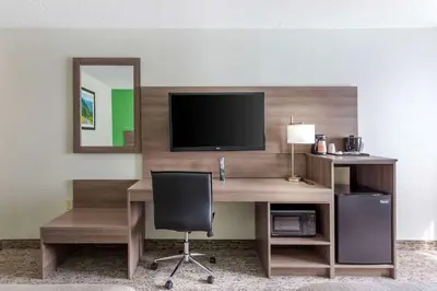 a desk with a television and a chair in a room at Quality Inn Ripley in Ripley