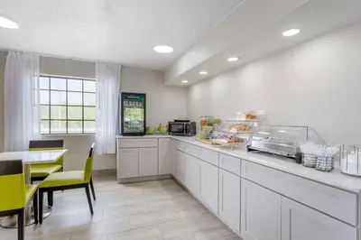 a kitchen with a counter and a table and chairs at Quality Inn Ripley in Ripley