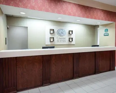 a lobby of a cancer clinic with a reception counter at Comfort Suites Parkersburg South in Mineralwells