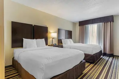 a hotel room with two beds and two lamps at Comfort Inn & Suites Triadelphia - Wheeling in Triadelphia