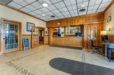 a large room with wooden walls and a desk at Comfort Inn & Suites Triadelphia - Wheeling in Triadelphia