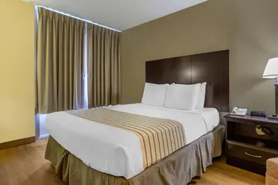 a hotel room with a large bed and a window at Econo Lodge Inn & Suites Triadelphia - Wheeling in Triadelphia