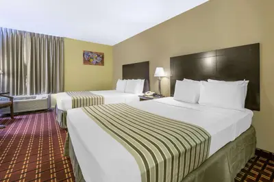 a hotel room with two beds and a window at Econo Lodge Inn & Suites Triadelphia - Wheeling in Triadelphia