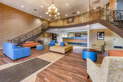 a lobby at a hospital with chairs and a staircase at Econo Lodge Inn & Suites Triadelphia - Wheeling in Triadelphia