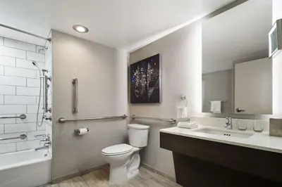 a bathroom with a toilet and a sink at DoubleTree by Hilton Pittsburgh Airport in Moon Township