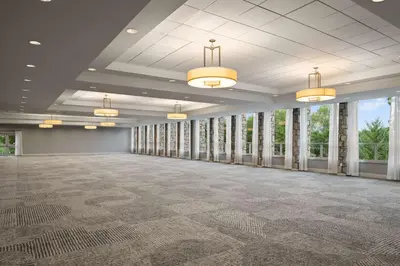 an empty room with windows and a large room with a large ballroom at DoubleTree by Hilton Pittsburgh Airport in Moon Township