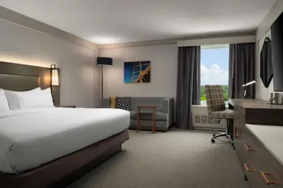 a hotel room with a large bed and a desk at DoubleTree by Hilton Pittsburgh Airport in Moon Township