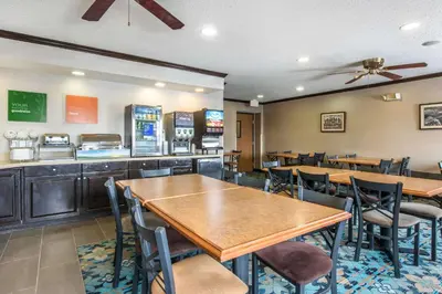 a restaurant with tables and chairs and a bar at Comfort Inn Weirton - Steubenville in Weirton