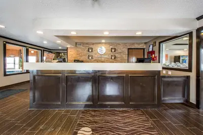 a bar with brown cabinets in a room at Comfort Inn Weirton - Steubenville in Weirton