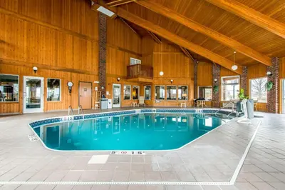 a large swimming pool in a building with a wooden ceiling at Comfort Inn Weirton - Steubenville in Weirton