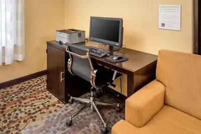 a room with a desk with a computer and a chair at Sleep Inn Charleston North in Charleston