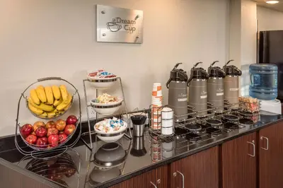 a breakfast counter with fruits and vegetables in a hotel room at Sleep Inn Charleston North in Charleston