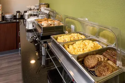 a buffet with many different types of food in trays at Sleep Inn Charleston North in Charleston