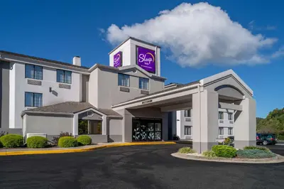 a hotel with a purple sign on top of it at Sleep Inn Charleston North in Charleston