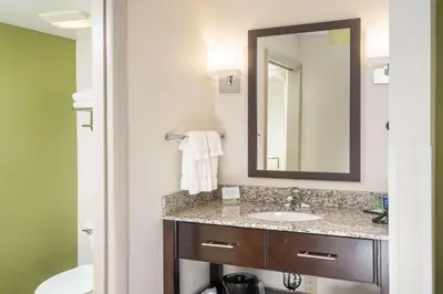 a bathroom with a sink and a mirror at Sleep Inn Charleston North in Charleston
