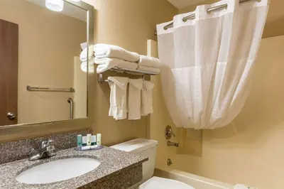 a bathroom with a sink and a toilet and a mirror at Quality Inn I-74 Batesville in Batesville