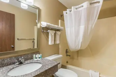 a bathroom with a sink and a toilet and a mirror at Quality Inn I-74 Batesville in Batesville