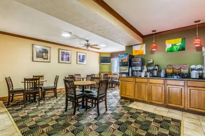 a restaurant with tables and chairs and a bar at Quality Inn I-74 Batesville in Batesville