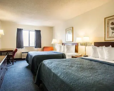 a hotel room with two beds and a window at Quality Inn Dundee in Dundee