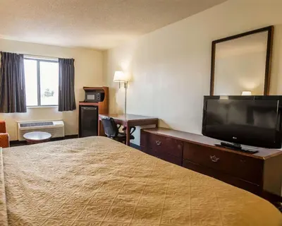 a hotel room with a bed and a flat screen tv at Quality Inn Dundee in Dundee